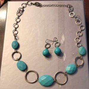 Silver and turquoise colored necklace and earrings set